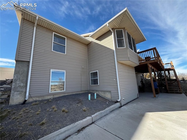 view of home's exterior featuring a deck and a patio