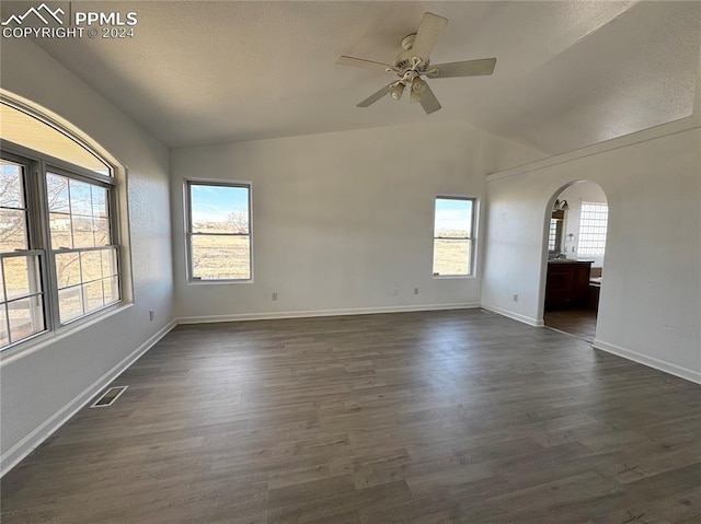 empty room with dark hardwood / wood-style floors, ceiling fan, and lofted ceiling