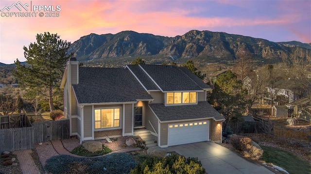 view of front of property with a garage and a mountain view