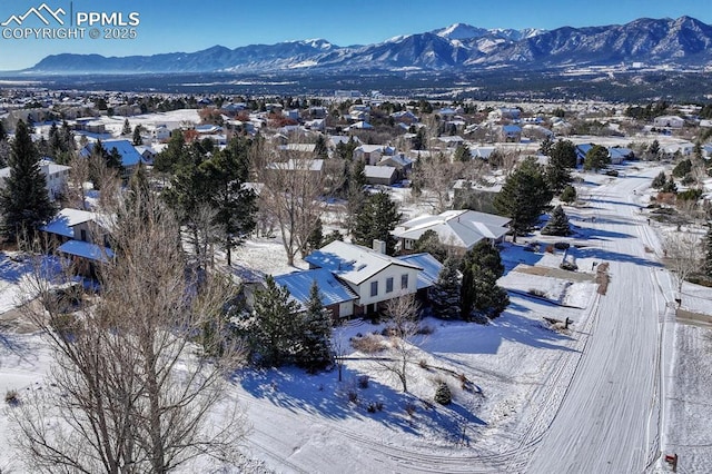 snowy aerial view with a mountain view