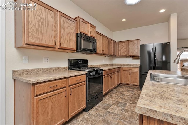 kitchen with sink and black appliances