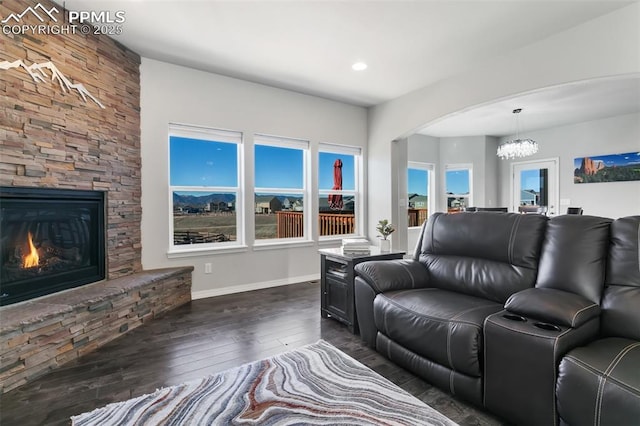 living room with a fireplace and dark wood-type flooring