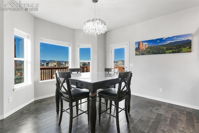 dining area featuring a notable chandelier and dark hardwood / wood-style floors