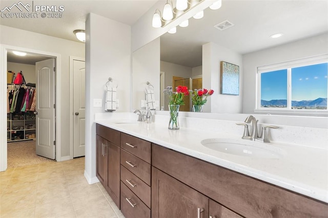 bathroom with vanity, tile patterned floors, and an enclosed shower