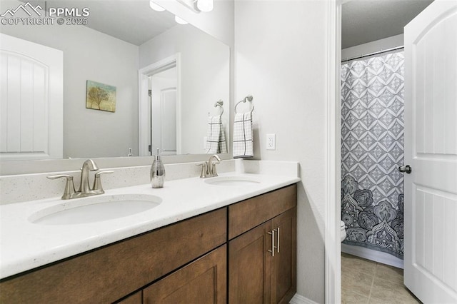 bathroom with a shower with shower curtain, vanity, and tile patterned floors