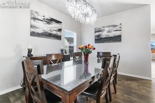 dining area featuring dark hardwood / wood-style flooring and an inviting chandelier