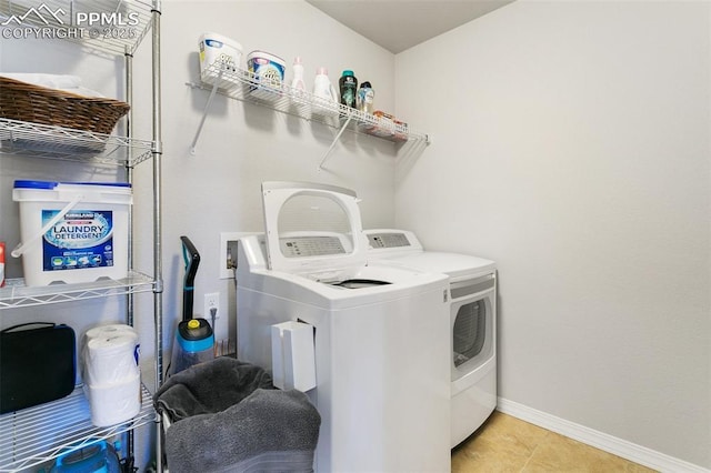 washroom with light tile patterned floors and separate washer and dryer