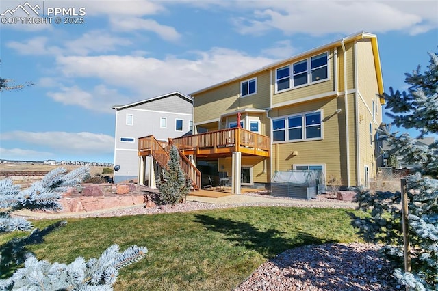 rear view of property featuring a yard, a hot tub, and a deck