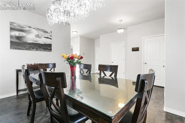 dining area featuring a chandelier and dark hardwood / wood-style floors