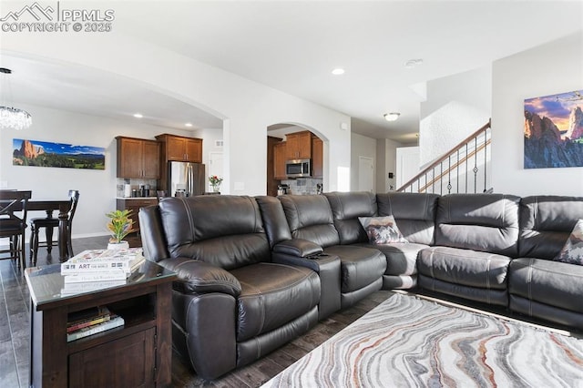 living room featuring dark wood-type flooring and a chandelier