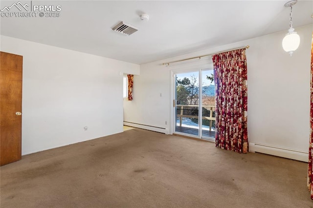 carpeted empty room featuring baseboard heating