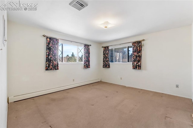 unfurnished room featuring carpet flooring, a healthy amount of sunlight, and a baseboard heating unit