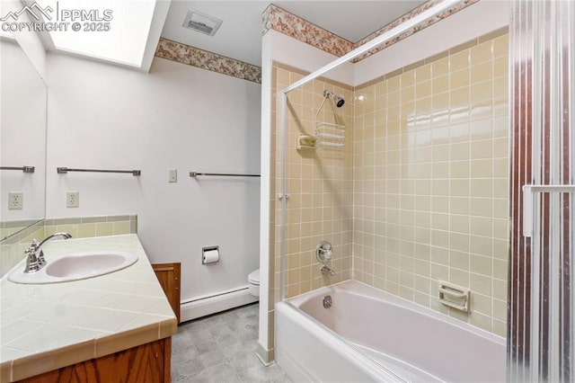 full bathroom with baseboard heating, vanity, tiled shower / bath combo, and toilet