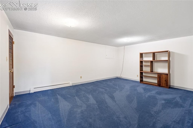 carpeted empty room featuring a textured ceiling and a baseboard heating unit