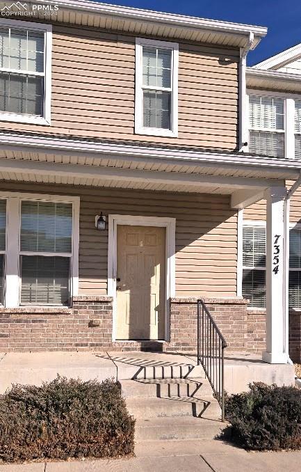 view of exterior entry featuring a porch