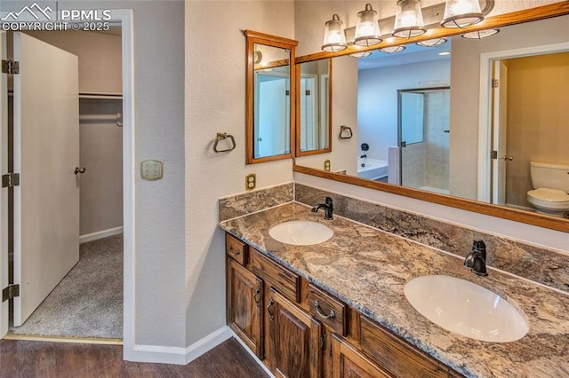 bathroom featuring vanity, a bathtub, toilet, and hardwood / wood-style flooring