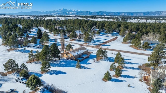 snowy aerial view with a mountain view