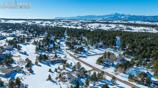 snowy aerial view with a mountain view