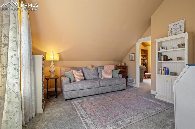 carpeted living room with lofted ceiling