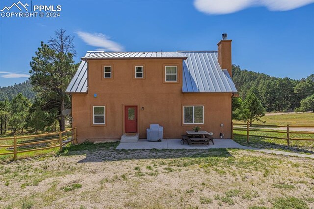 rear view of property featuring a patio area