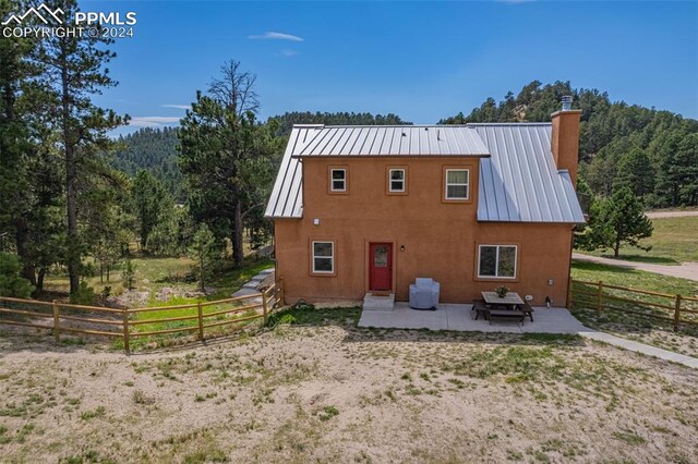 back of house with a patio