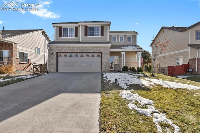 front of property featuring a front yard and a garage