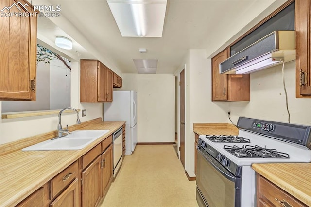 kitchen featuring sink, exhaust hood, and white appliances