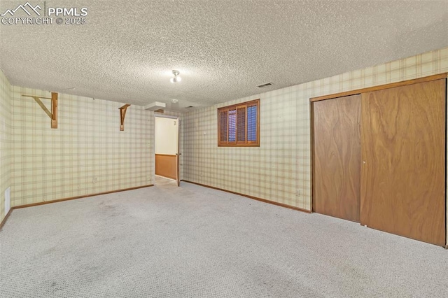 basement with light carpet and a textured ceiling