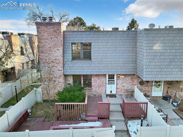 rear view of house featuring a deck