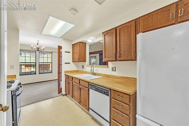 kitchen featuring light carpet, white appliances, an inviting chandelier, and sink