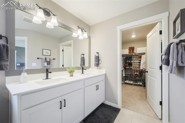 bathroom with tile patterned floors and vanity