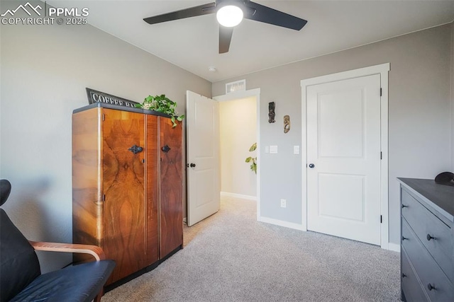 living area featuring ceiling fan and light carpet