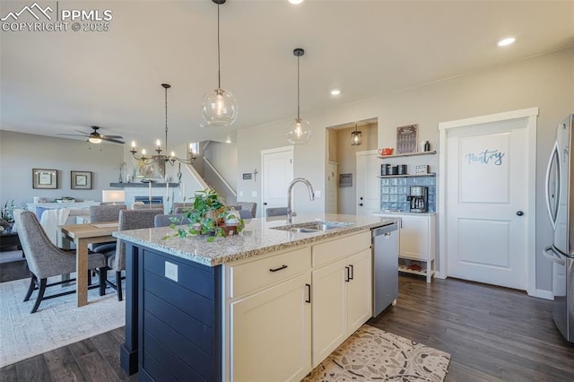 kitchen featuring stainless steel appliances, a kitchen island with sink, ceiling fan, sink, and white cabinets