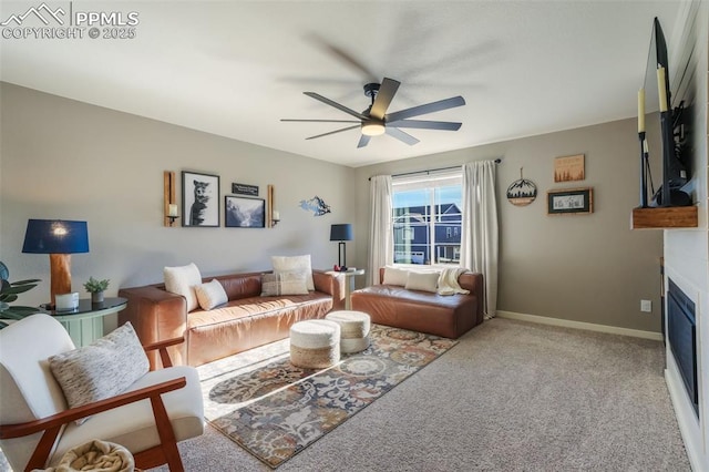 living room with light carpet, a fireplace, and ceiling fan