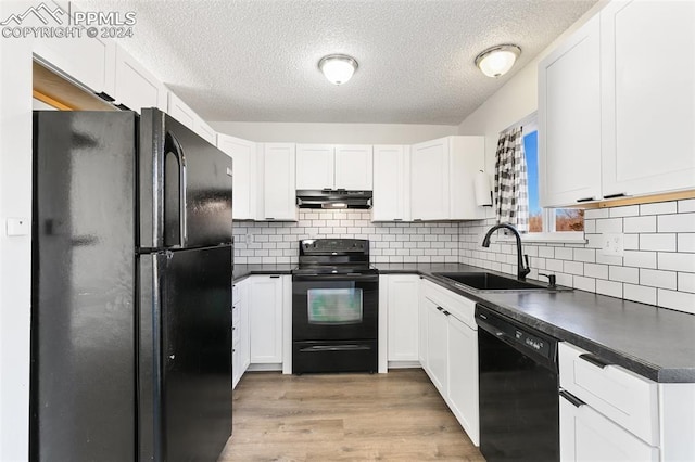 kitchen featuring light wood-type flooring, a textured ceiling, sink, black appliances, and white cabinets