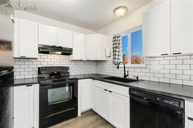 kitchen featuring black appliances, sink, light hardwood / wood-style flooring, a textured ceiling, and white cabinetry