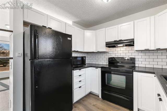 kitchen featuring black appliances, white cabinetry, and hardwood / wood-style flooring