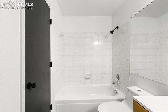 full bathroom with vanity, toilet, and tiled shower / bath combo