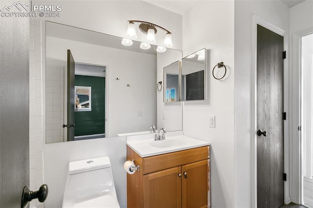 bathroom featuring vanity and toilet