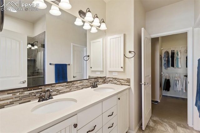 bathroom with vanity, decorative backsplash, and tiled shower