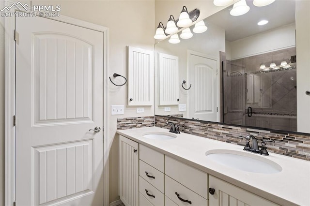 bathroom featuring backsplash, vanity, and walk in shower