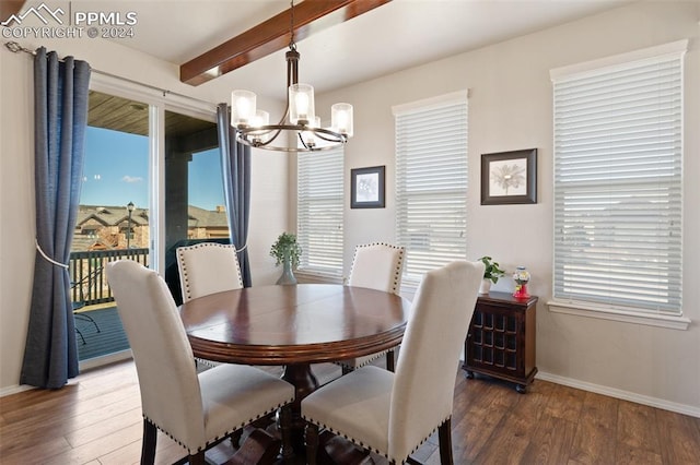 dining room featuring a wealth of natural light, dark wood-type flooring, and an inviting chandelier