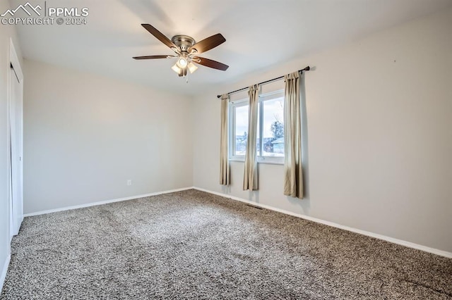 carpeted empty room featuring ceiling fan