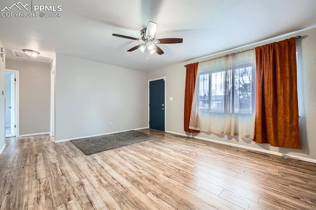 unfurnished room with light hardwood / wood-style flooring and ceiling fan