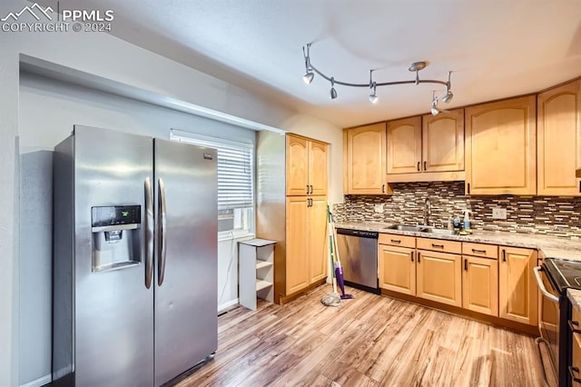 kitchen featuring light brown cabinets, light wood-type flooring, stainless steel appliances, and sink