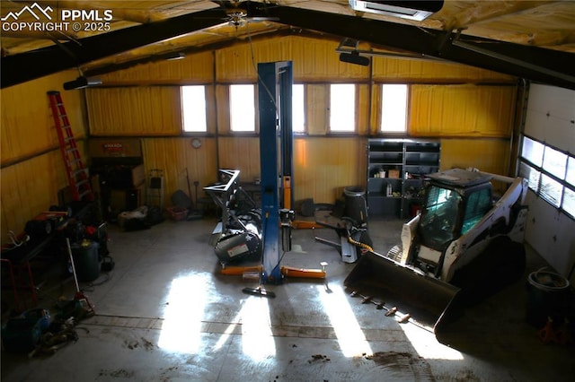 garage featuring a garage door opener and wooden walls