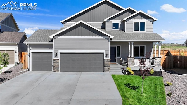 13358 Savannah Falls Ct, Peyton, CO 80831 - craftsman-style house with stone siding, board and batten siding, a porch, and an attached garage