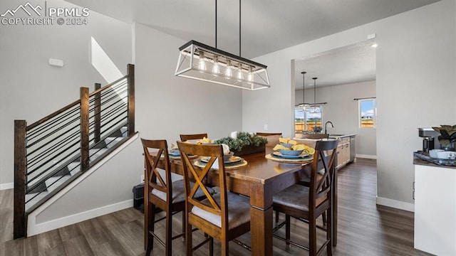 13358 Savannah Falls Ct, Peyton, CO 80831 - dining space with baseboards, dark wood-style floors, a chandelier, and stairway