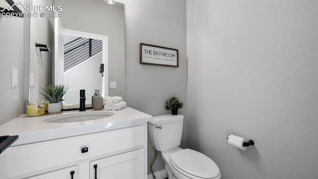 13358 Savannah Falls Ct, Peyton, CO 80831 - half bathroom featuring a textured wall, toilet, and vanity
