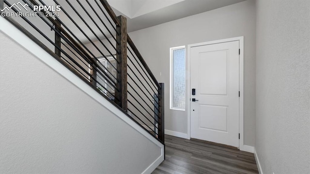 13358 Savannah Falls Ct, Peyton, CO 80831 - foyer entrance featuring baseboards, wood finished floors, and stairway